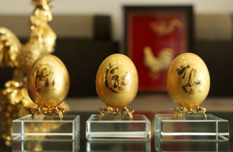 Quả trứng được mạ vàng, trên đó khắc các chữ Phúc - Lộc - Thọ